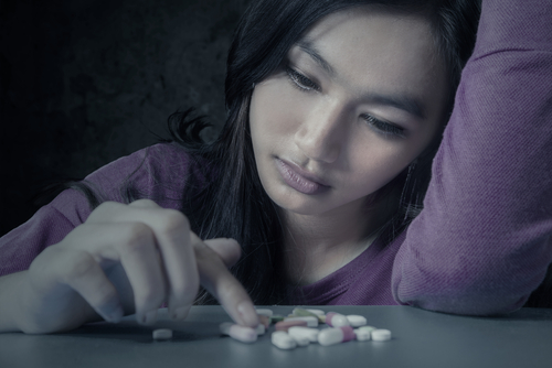 woman debating on taking pills