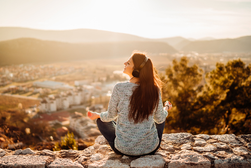 woman listening to music in nature