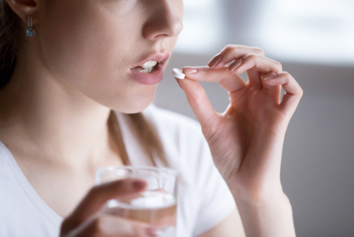 woman taking a pill