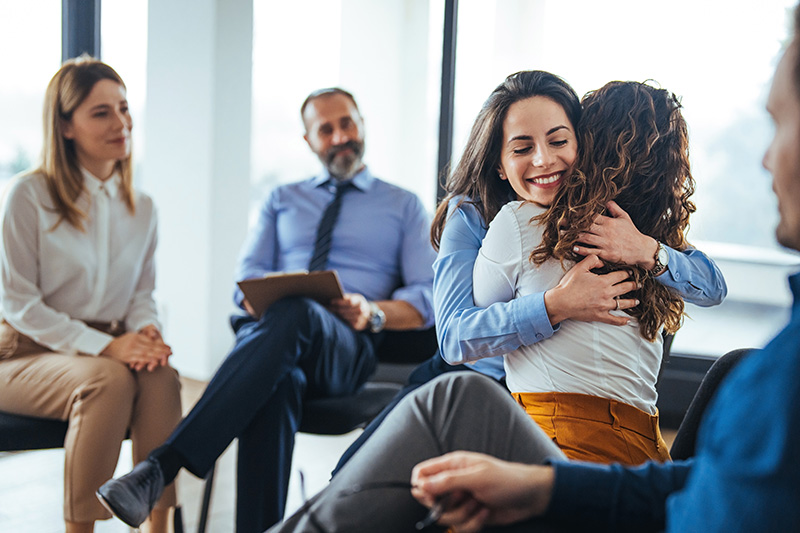 People participate in a group therapy session.