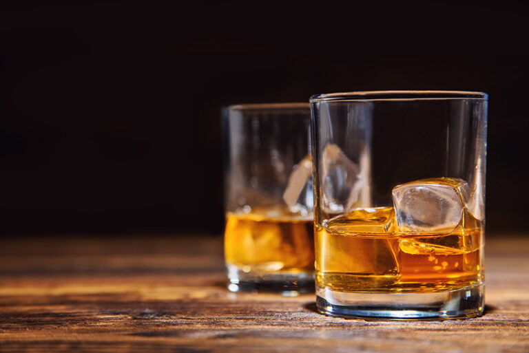 Alcoholic beverages sit on a table.