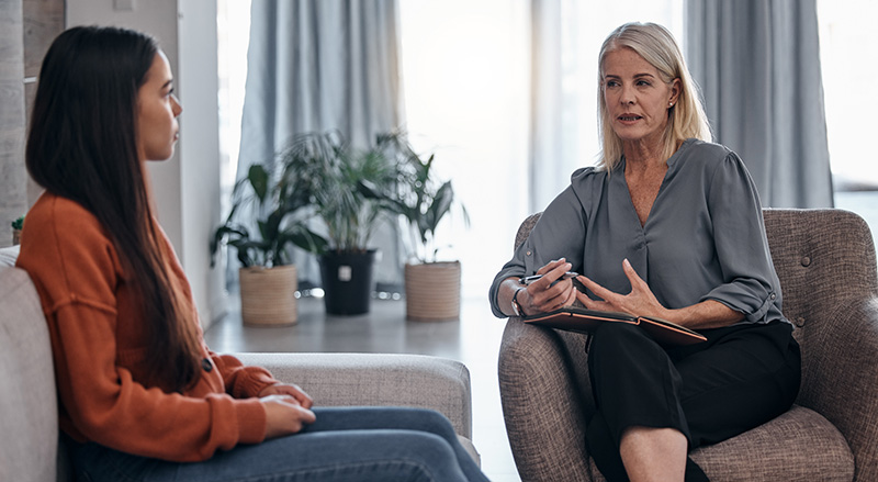 A woman participates in therapy at a drug rehab center.